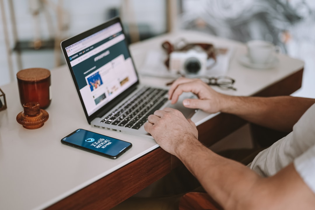 Photo by DaryaDarya LiveJournal a man sitting at a desk using a laptop computer
